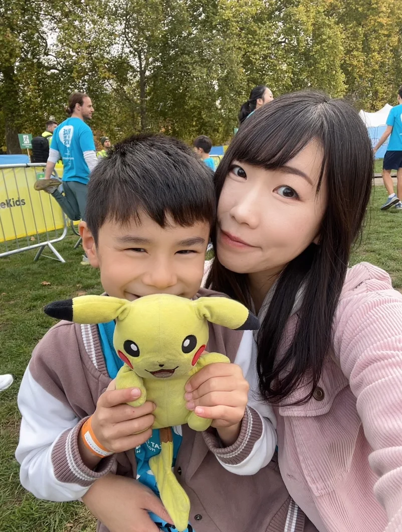 Joshua smiling and holding a Pikachu soft toy at RBC Race for the Kids